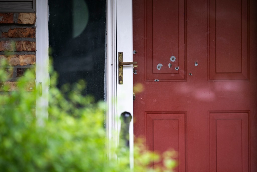 Red door with bullet holes.