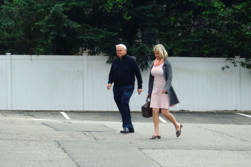 Bob Menendez and his wife walking near their home.