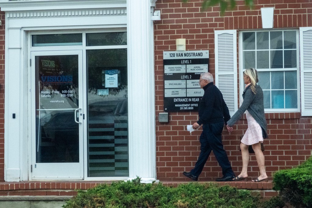 Bob Menendez and his wife walking near their home.
