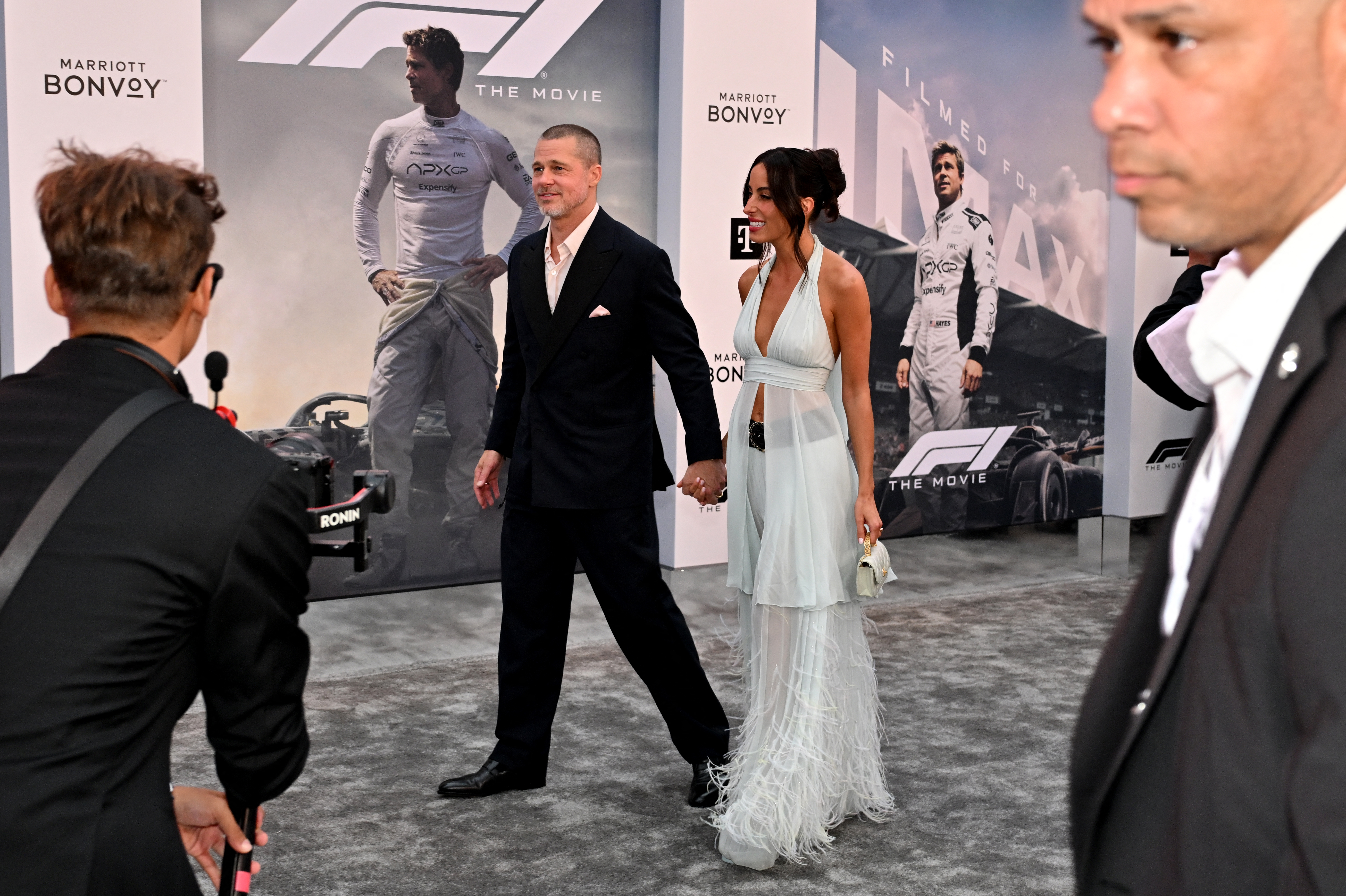 Brad Pitt and Ines de Ramon on a red carpet. 