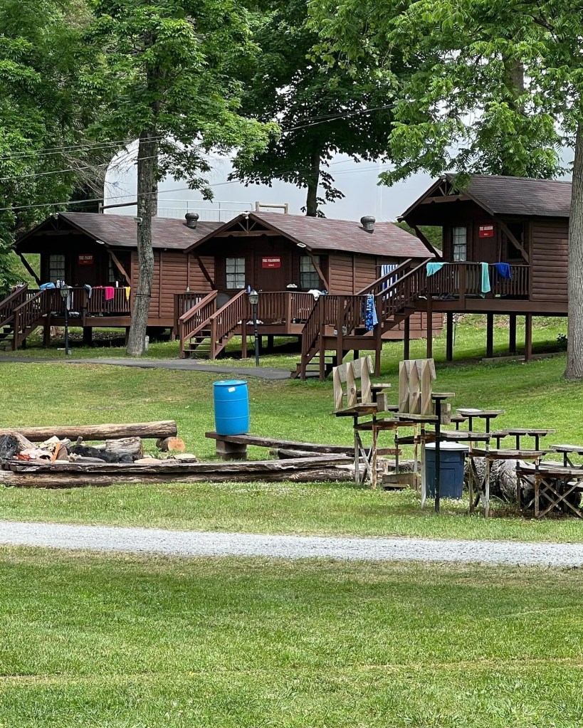Three cabins at a summer camp.