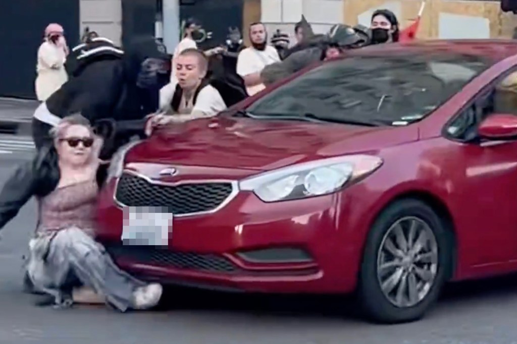 The protester was blocking the path of the car in downtown LA.