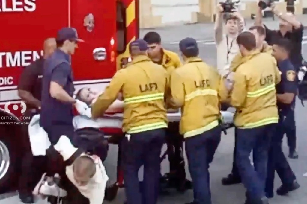 The woman getting loaded into an ambulance.