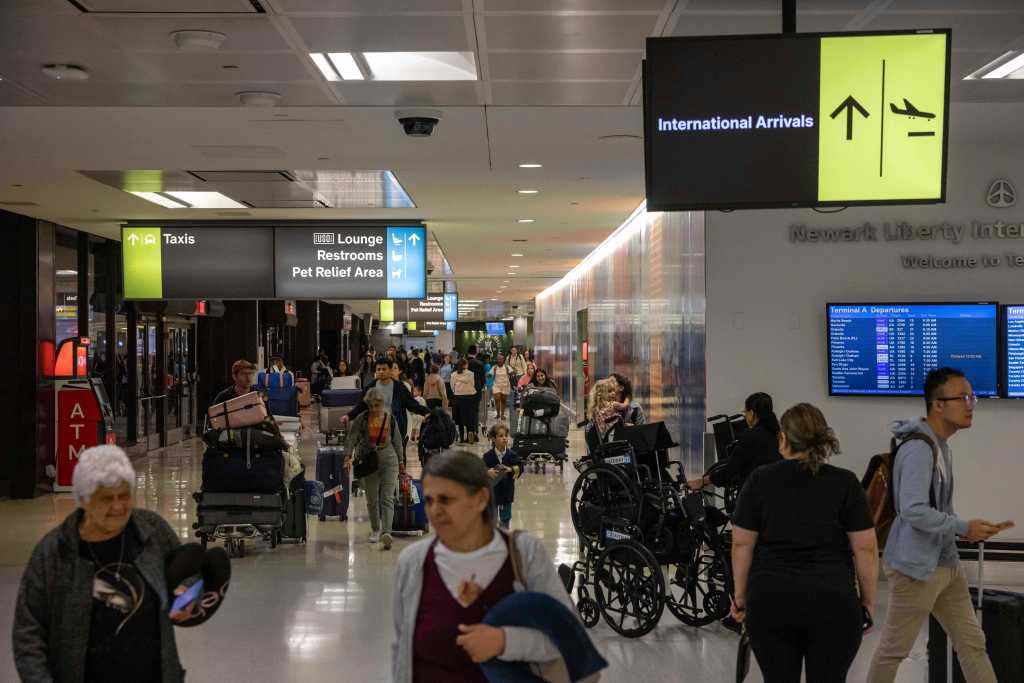 People carrying suitcases arrive from international flight at Newark Liberty International Airport, Monday, June 9, 2025, in New Jersey.