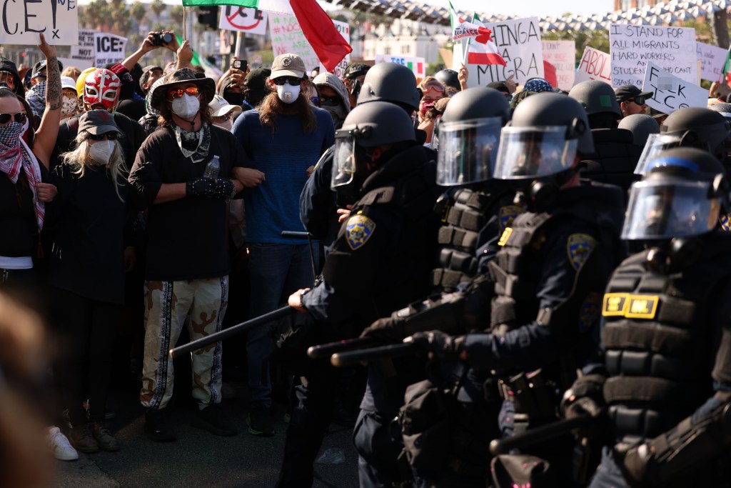 Protestors and riot police face off.