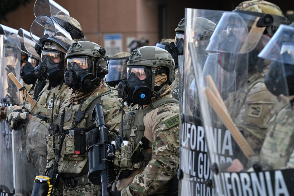 California National Guard members in riot gear at a protest.
