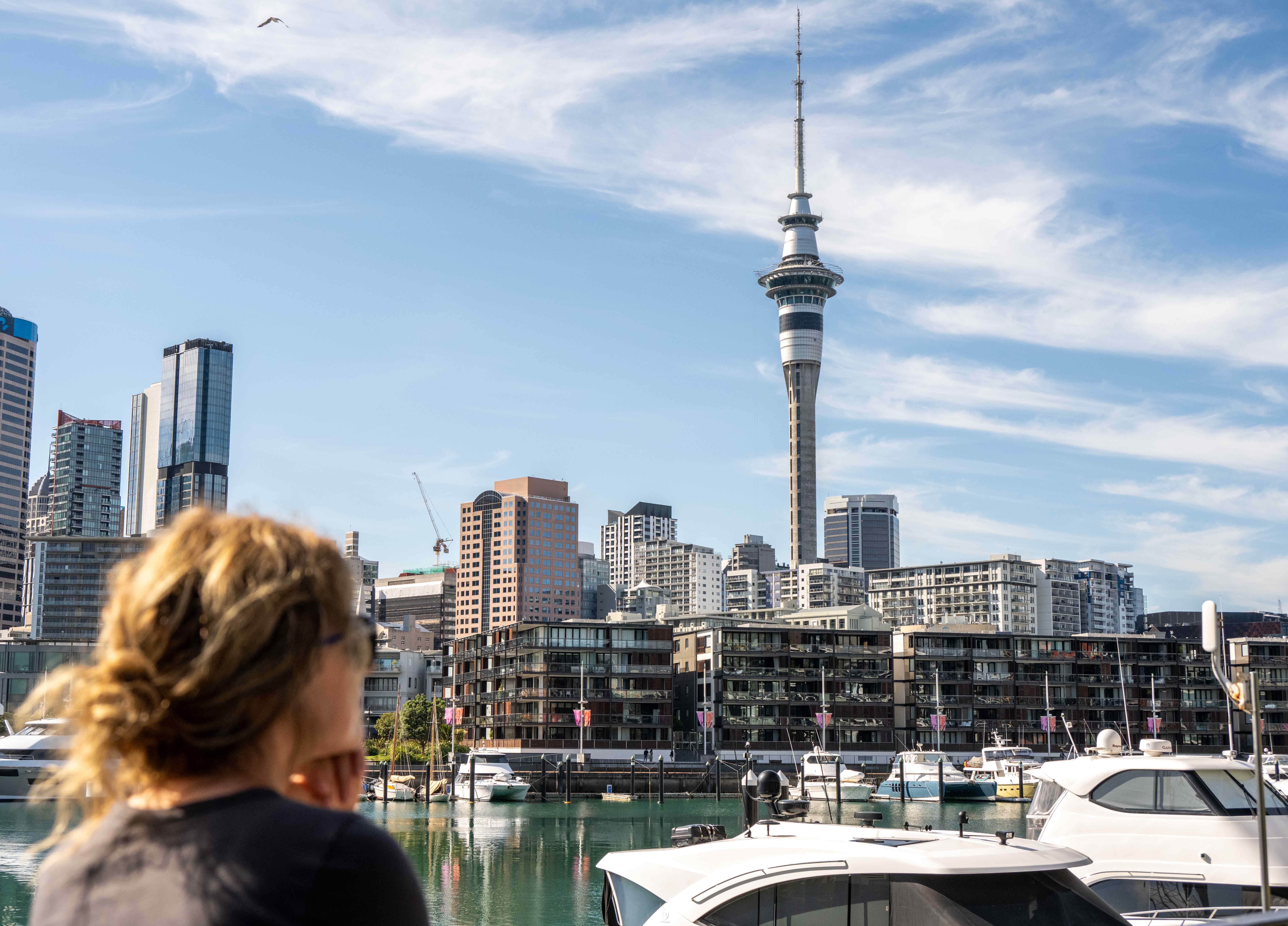 Woman standing in front of Auckland, New Zealand skyline