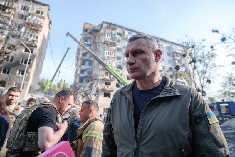Mayor of Kyiv Vitali Klitschko stands in front of partially collapsed residential building after Russian drone-and-missile attack.