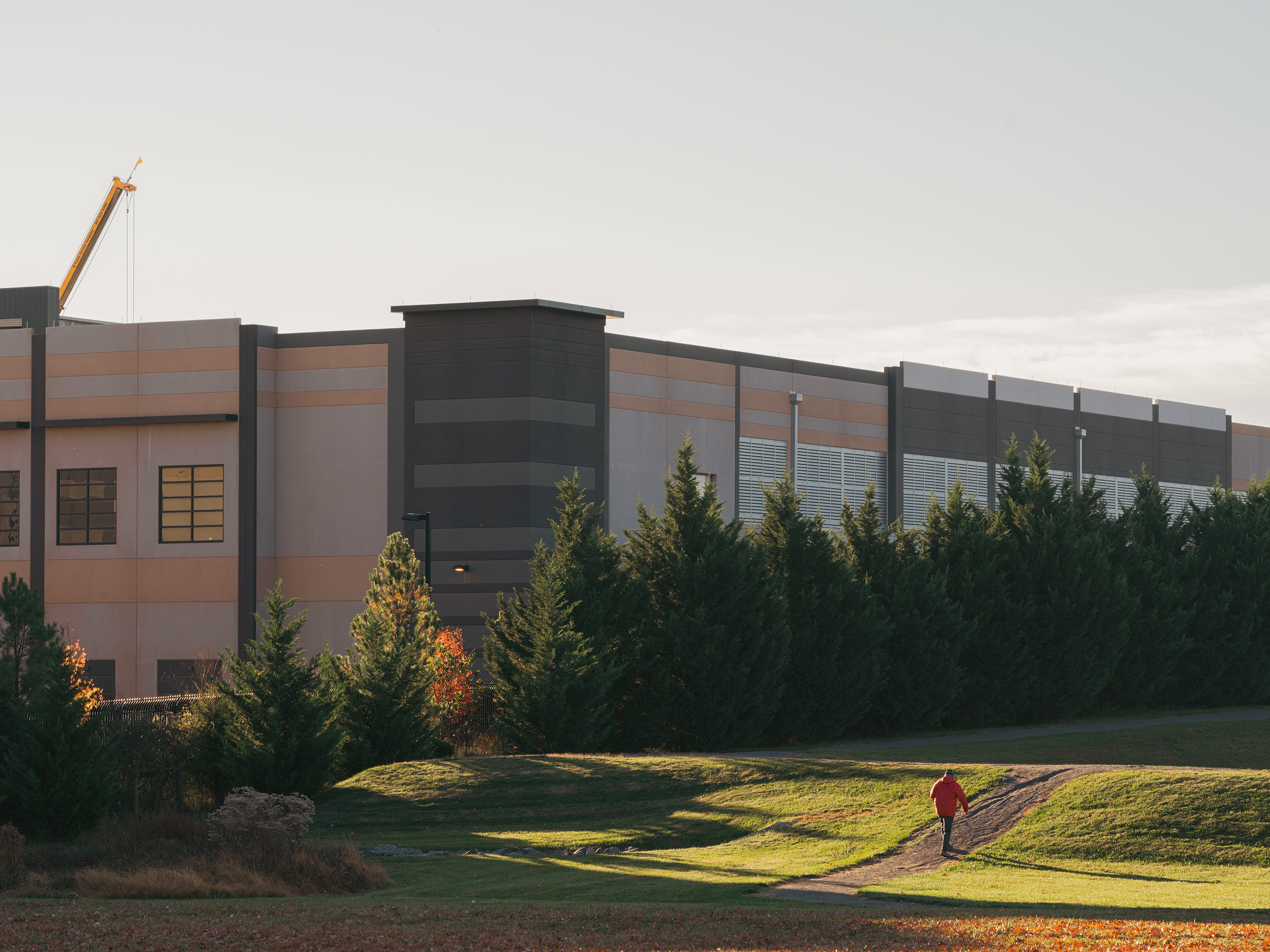 A person walking next to a data center