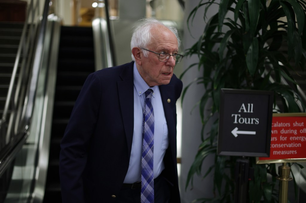 Senator Bernie Sanders walking near an escalator in the U.S. Capitol.
