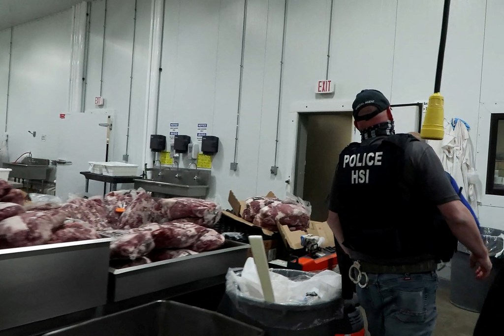 ICE agent during a raid at a meat production plant.