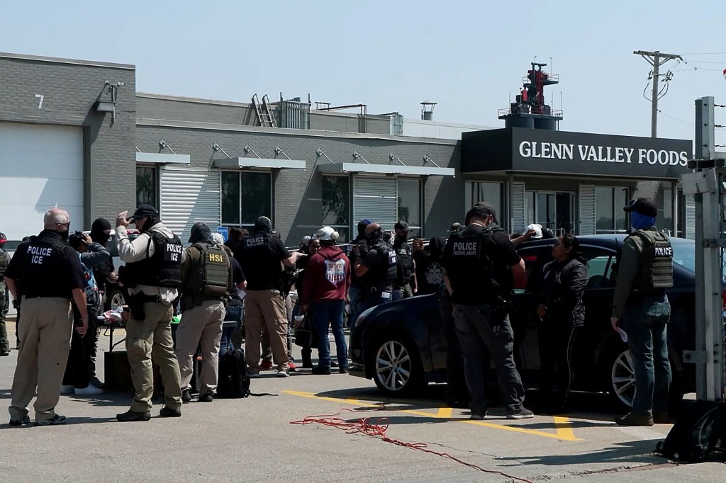 ICE agents conducting a raid at a Glenn Valley Foods meat production plant.