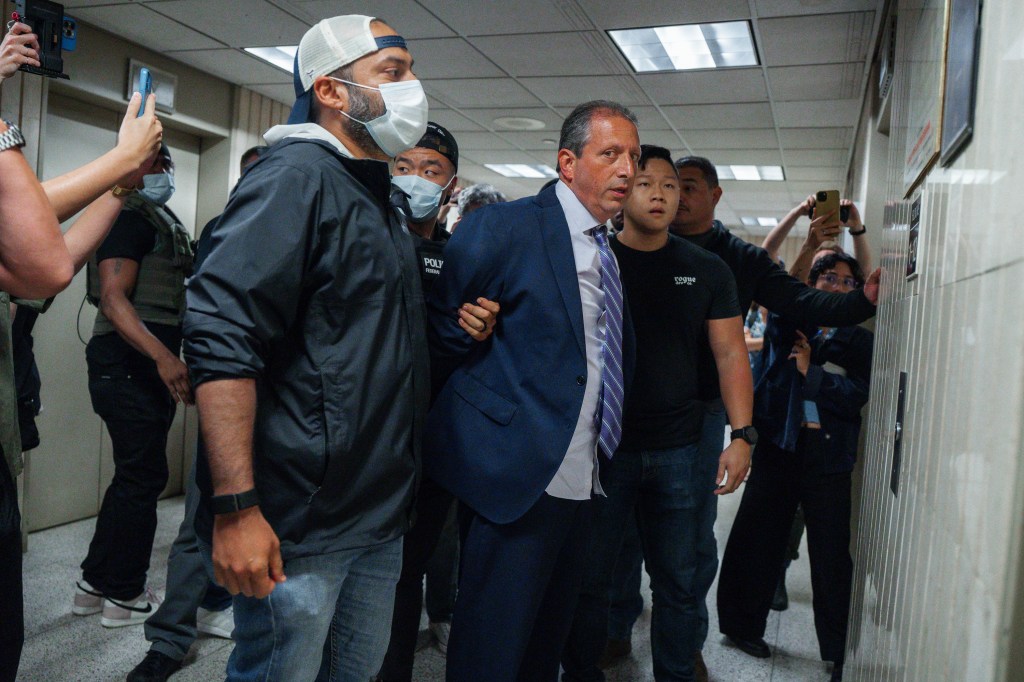 New York City Comptroller Brad Lander under arrest by ICE and FBI agents outside a federal immigration court.