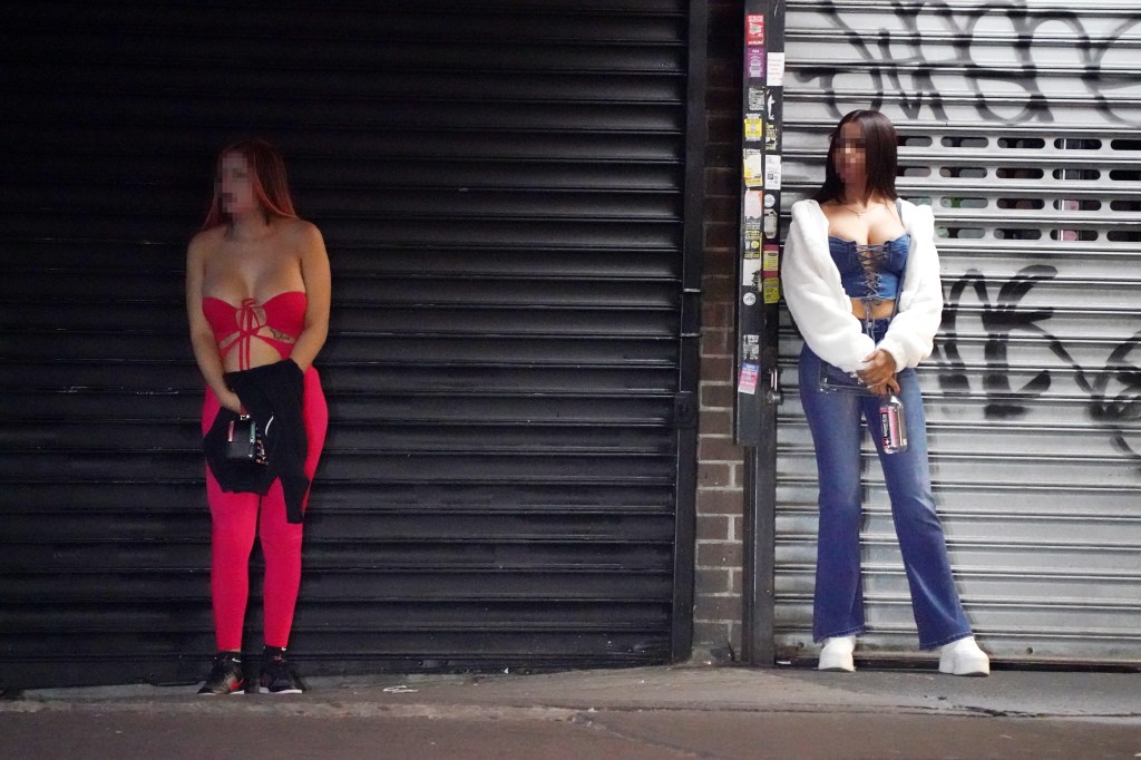 Two sex workers standing on a street in Queens, NY.