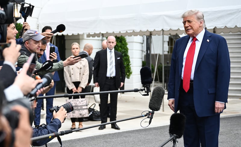 White House Press Secretary Karoline Leavitt and White House Deputy Chief of Staff for Policy and Homeland Security Advisor Stephen Miller watch US President Donald Trump speak to journalists as he makes his way to board Marine One before departing from the South Lawn of the White House in Washington, DC on June 15, 2025. Trump is headed to Canada to attend the G7 summit. (Photo by Mandel NGAN / AFP) (Photo by MANDEL NGAN/AFP via Getty Images)