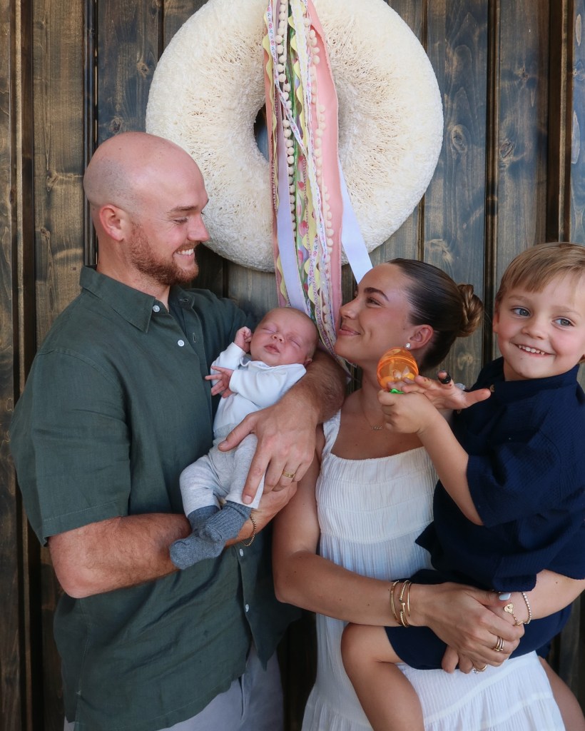 Family portrait with newborn baby, toddler, and parents.