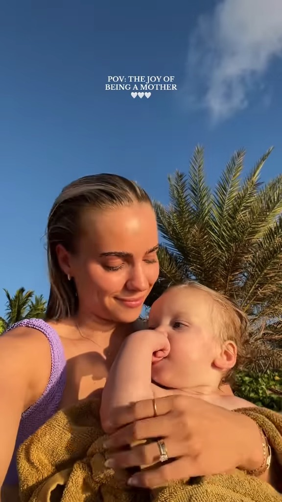 A mother holding her toddler son.