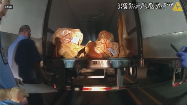Bodycam footage of a truck bed containing bags of jewelry after a heist.