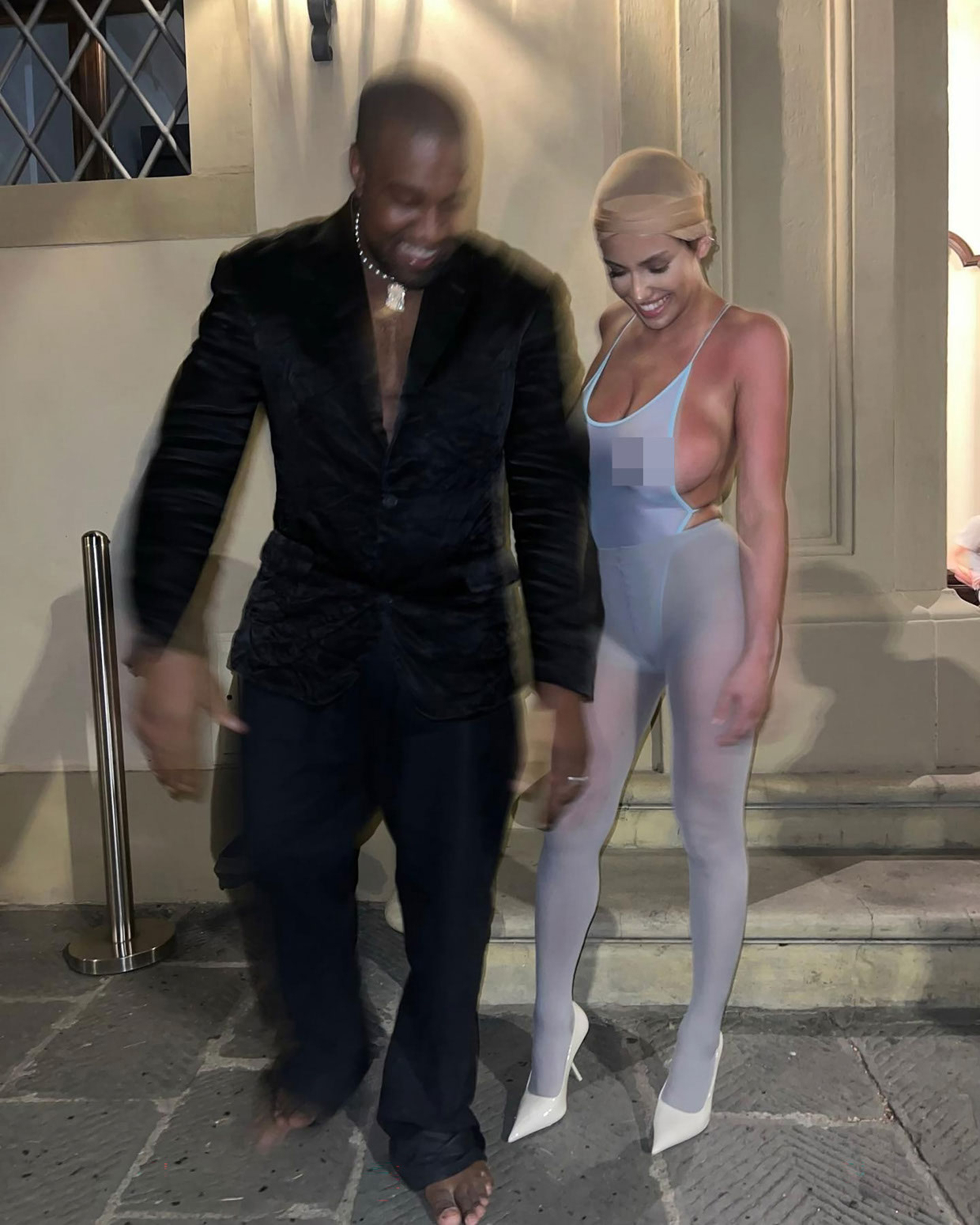 Bianca Censori walks with Kanye West. 