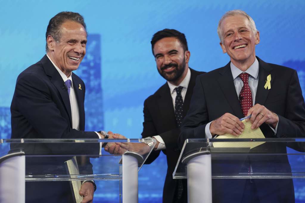 Former NY Gov. Andrew Cuomo shakes hands with mayoral candidate Zohran Mamdani next to Whitney Tilson after the Democratic mayoral primary debate on June 4, 2025. 