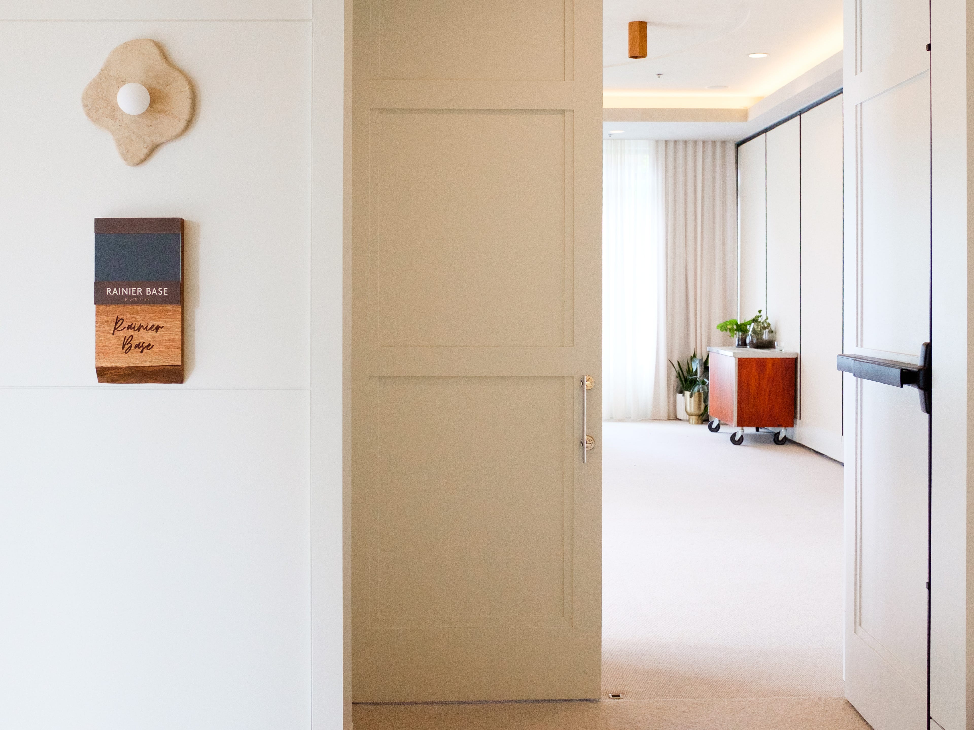The entrance to a white meeting room inside 1 Hotel Seattle