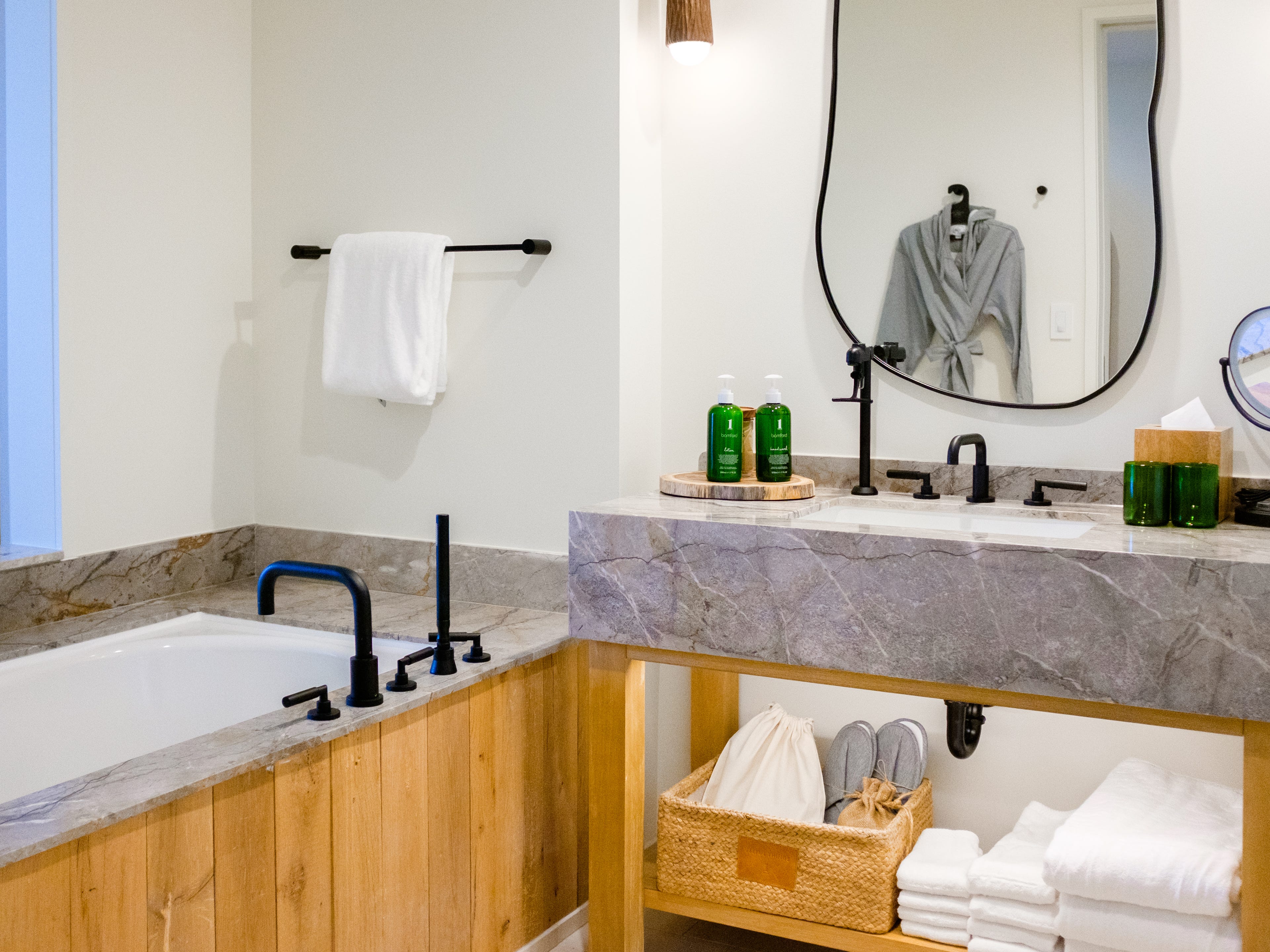 Inside a hotel bathroom with organic shapes and materials