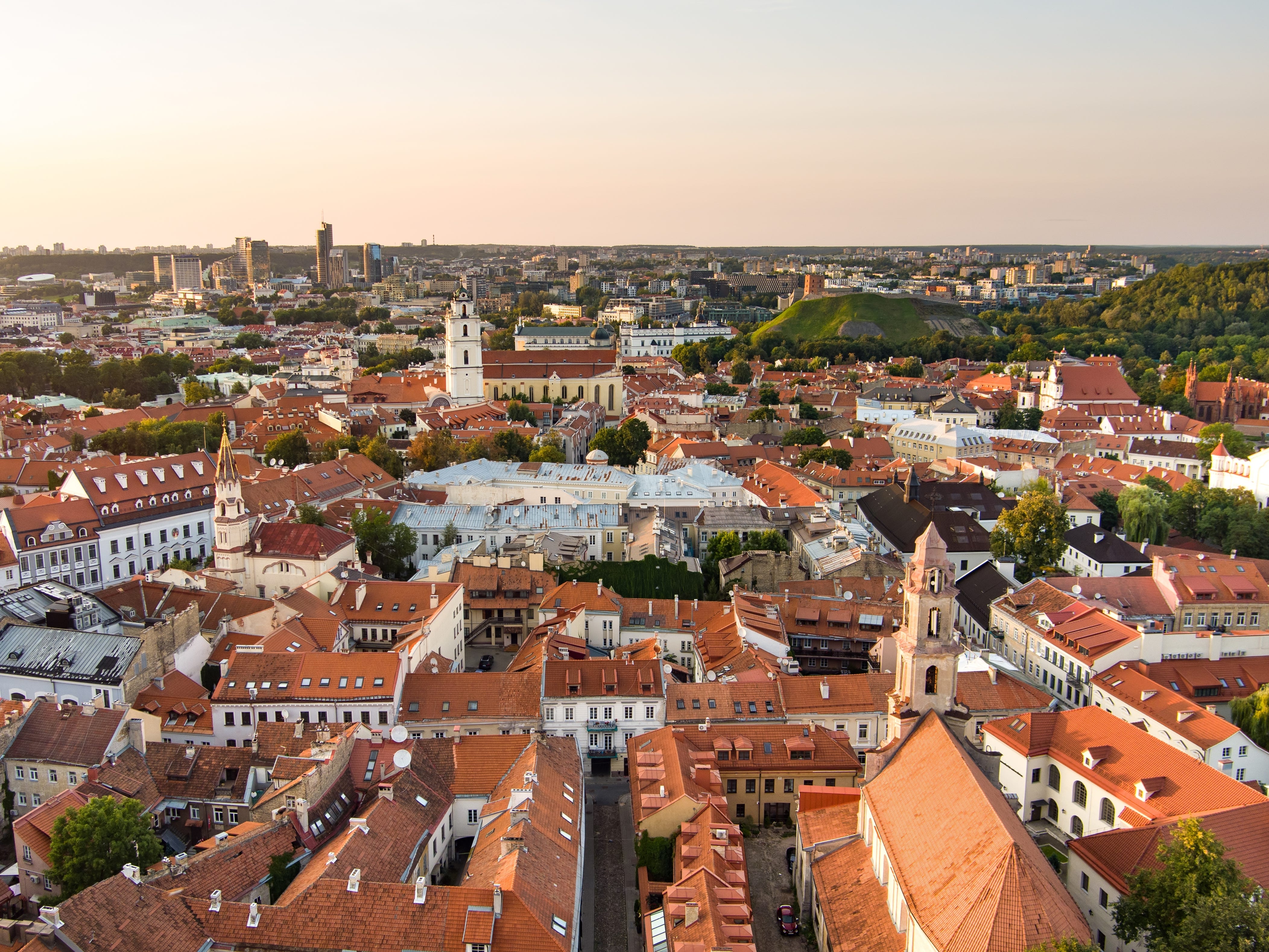 An aerial view of Old Town Vilnius, Lithuania, with red-roofed buildings.