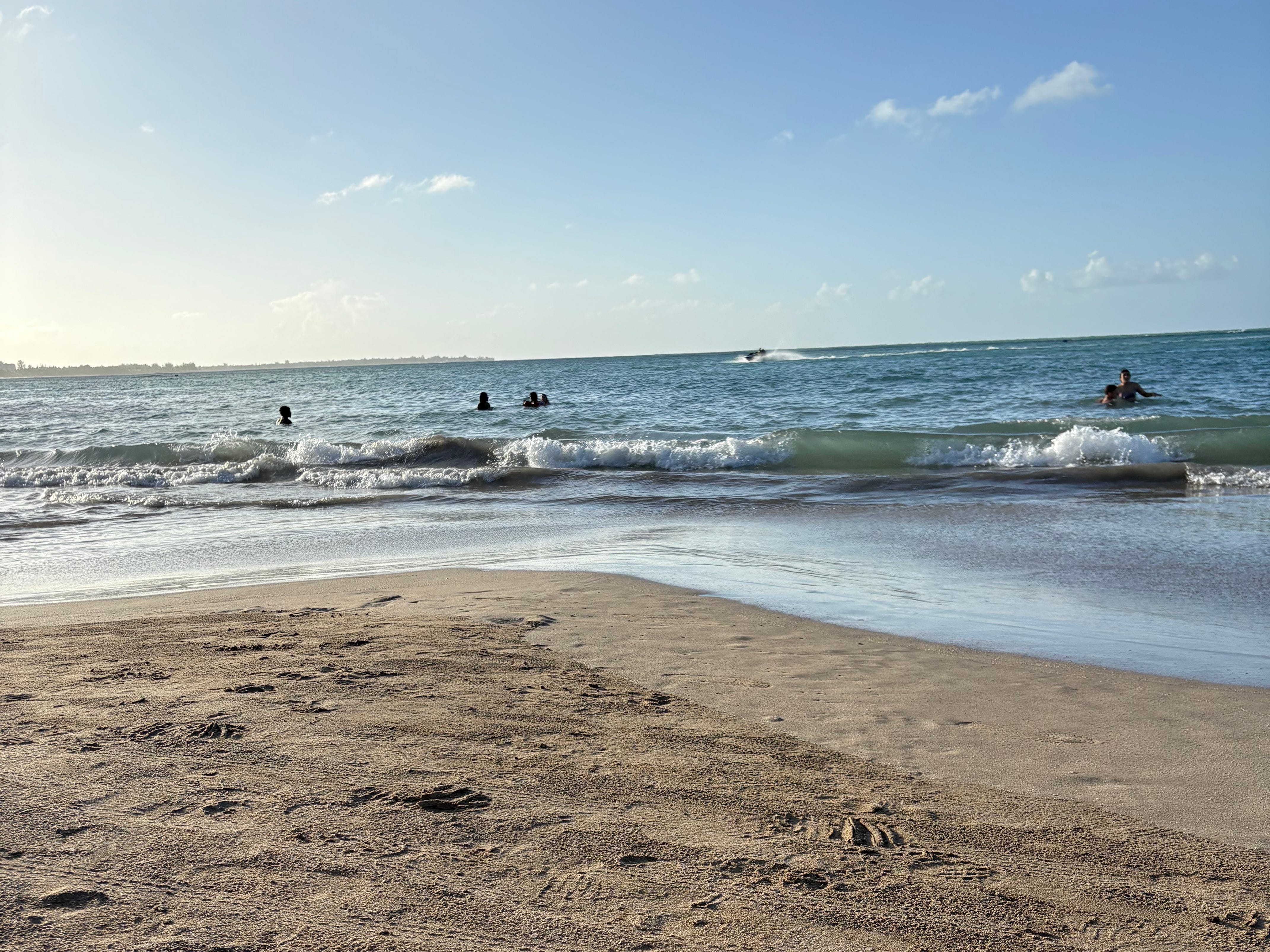 The author's view of the sand and ocean at Luquillo Beach in Puerto Rico.
