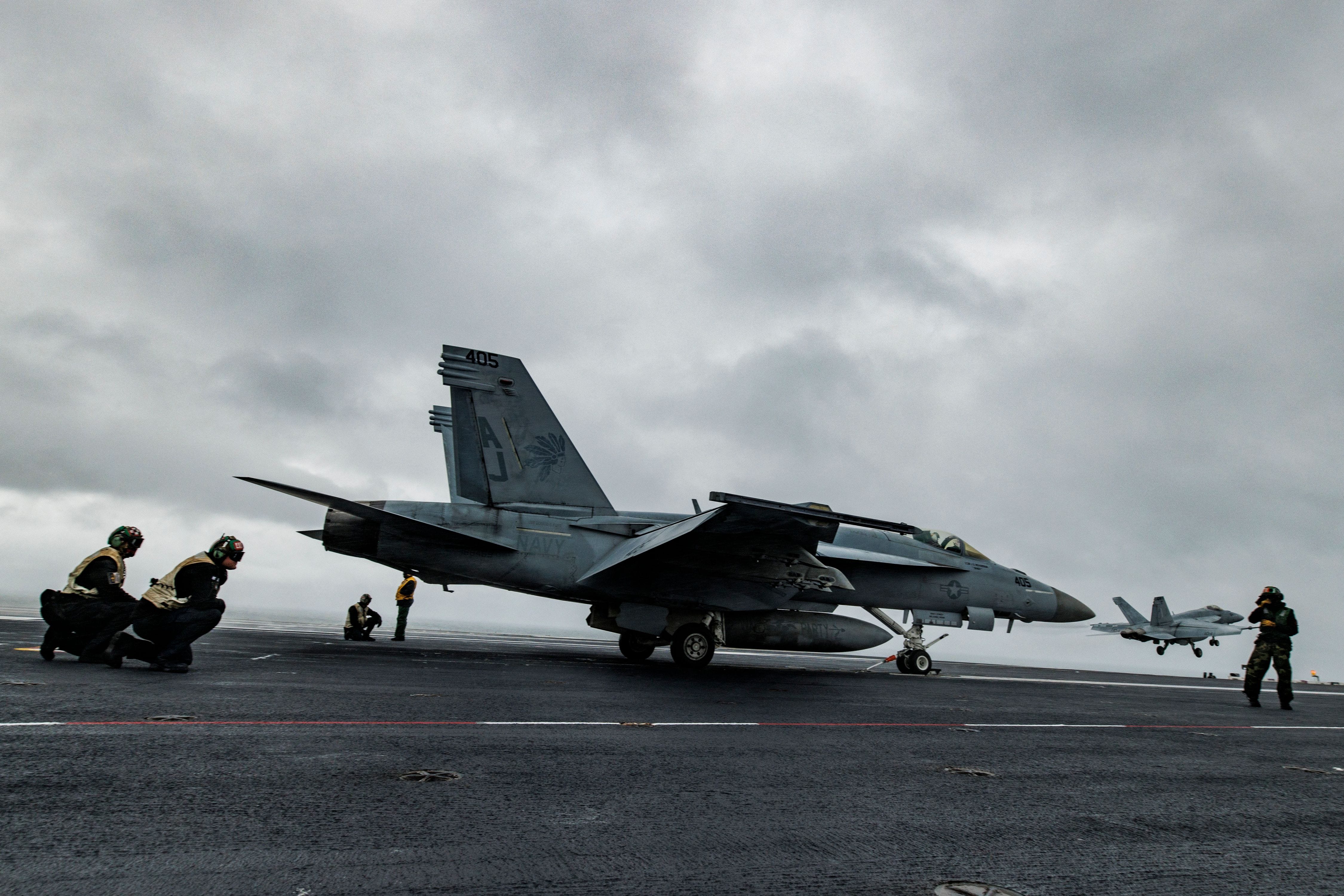 Sailors on the flight deck prepare to launch a F/A-18E Super Hornet with Strike Fighter Squadron 37 (VFA-37) as another Super Hornet is launched from the USS Gerald Ford in the Atlantic Ocean off the coast of the US on October 5, 2022.