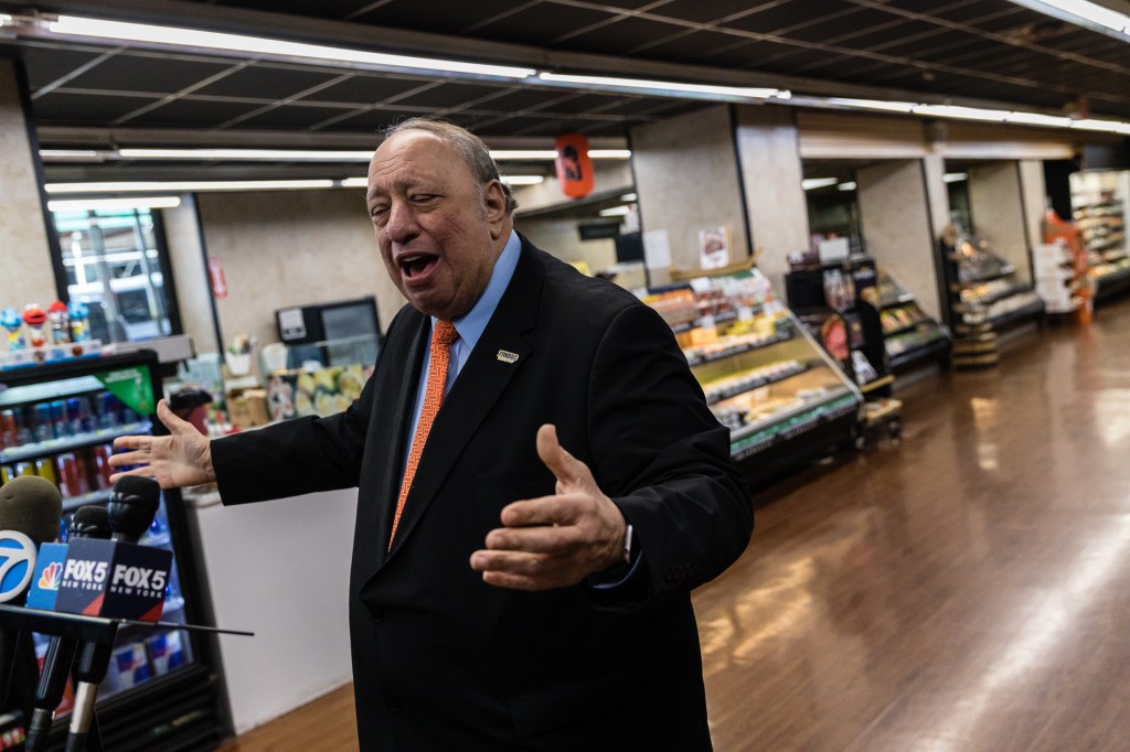 John Catsimatidis speaking at a press conference in a Gristedes supermarket.