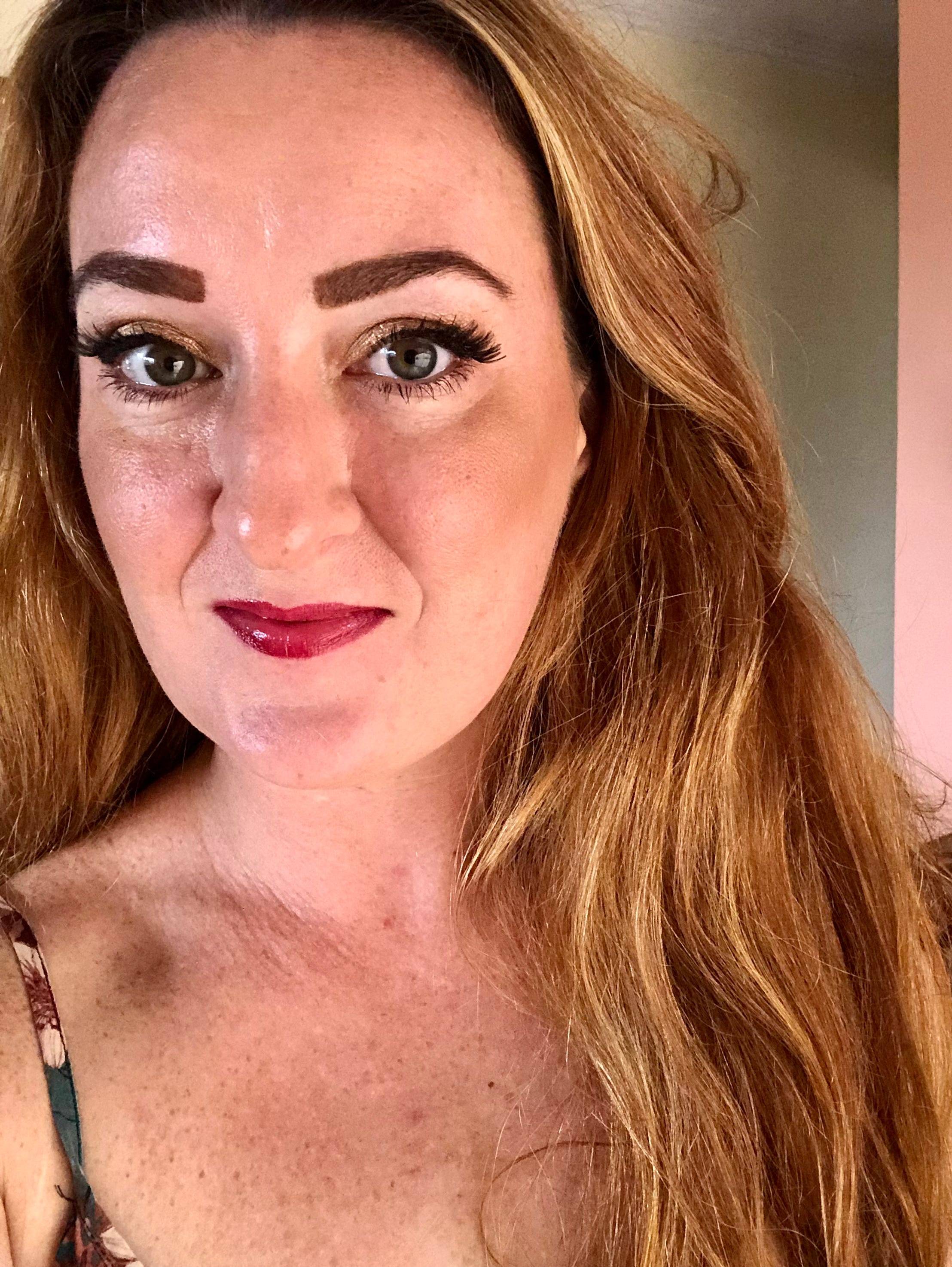 Profile of a woman wearing red lipstick.
