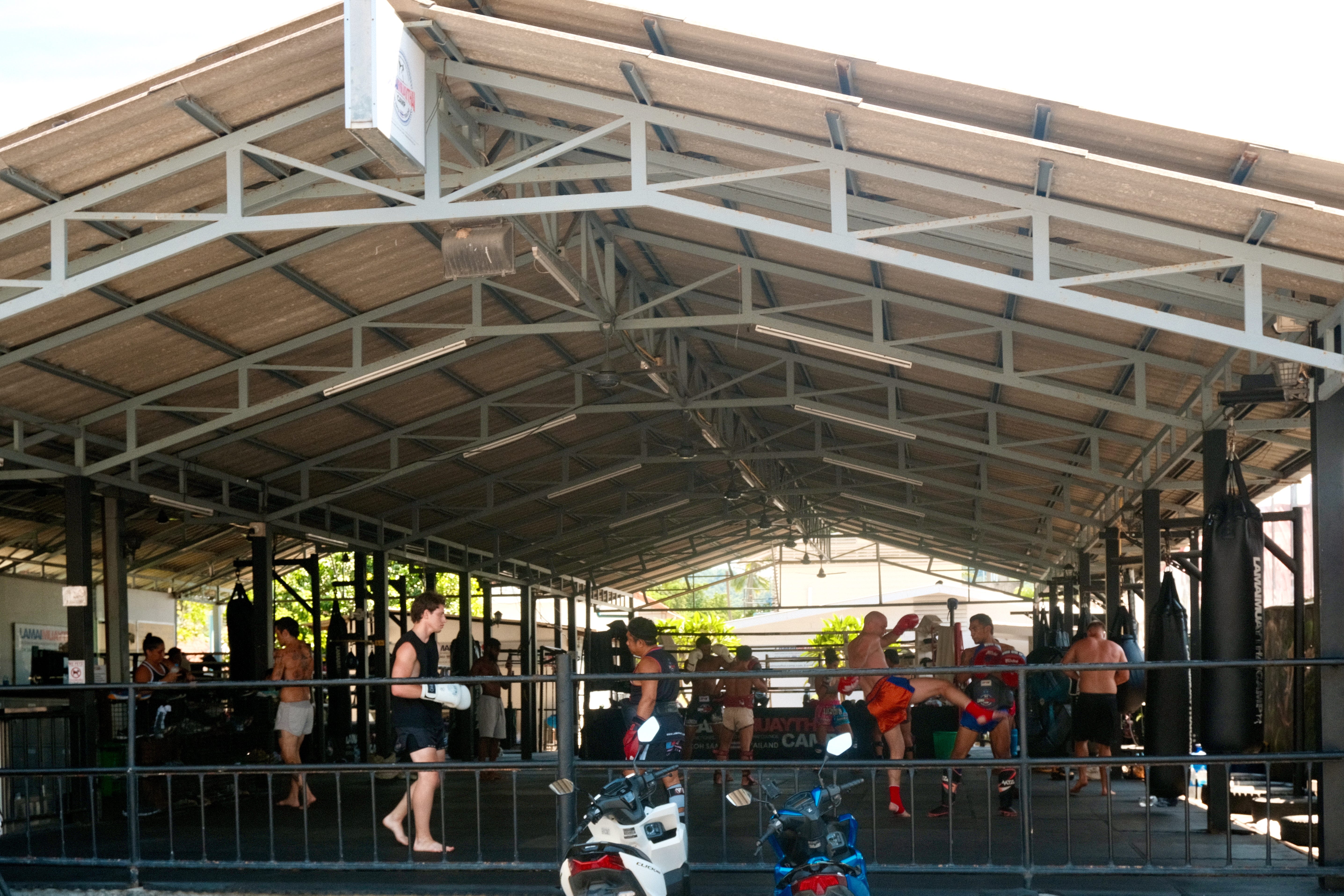 A bunch of people taking Muay Thai lessons at a Muay Thai gym in Koh Samui, Thailand.