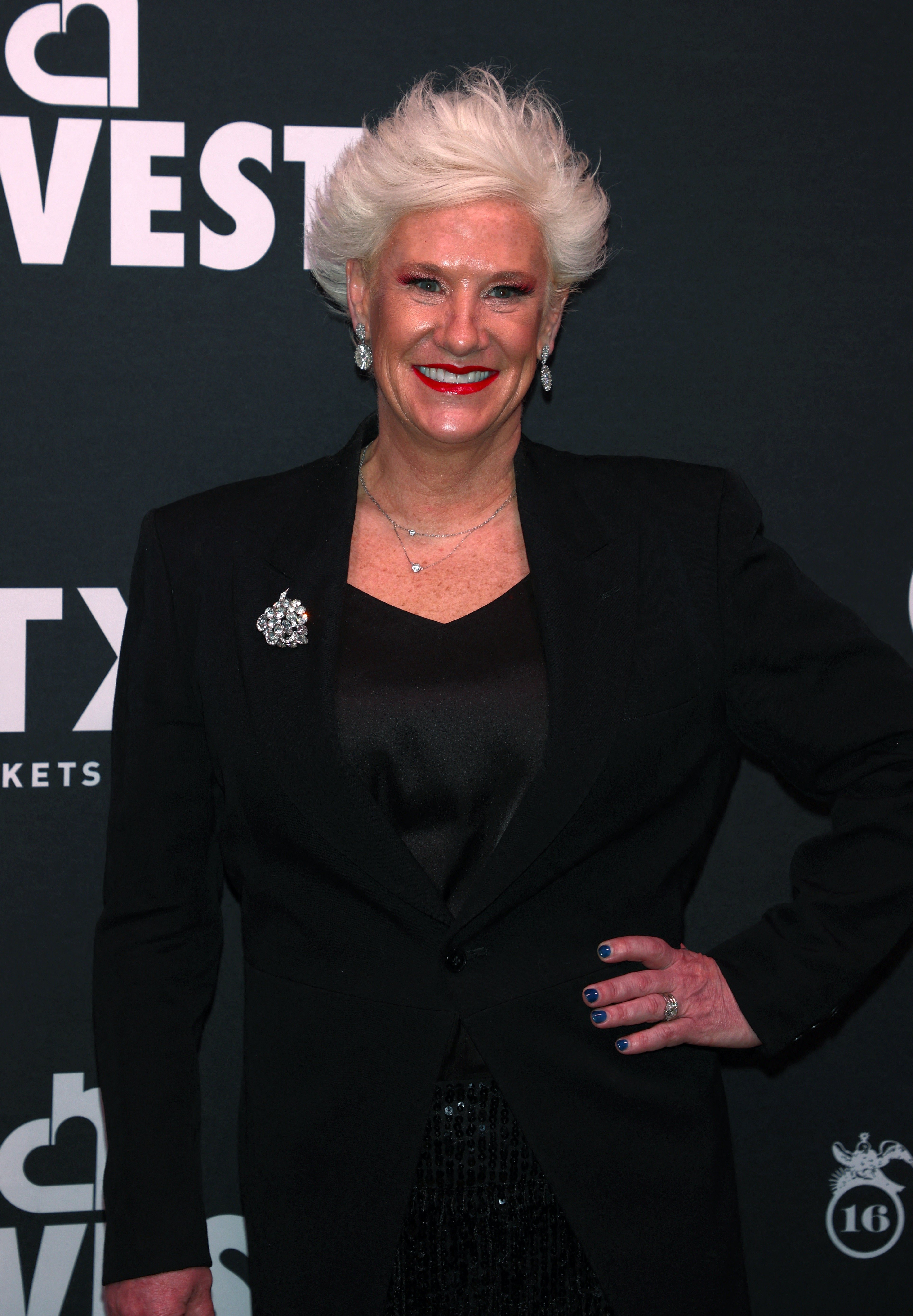 Anne Burrell wears black at an event. 
