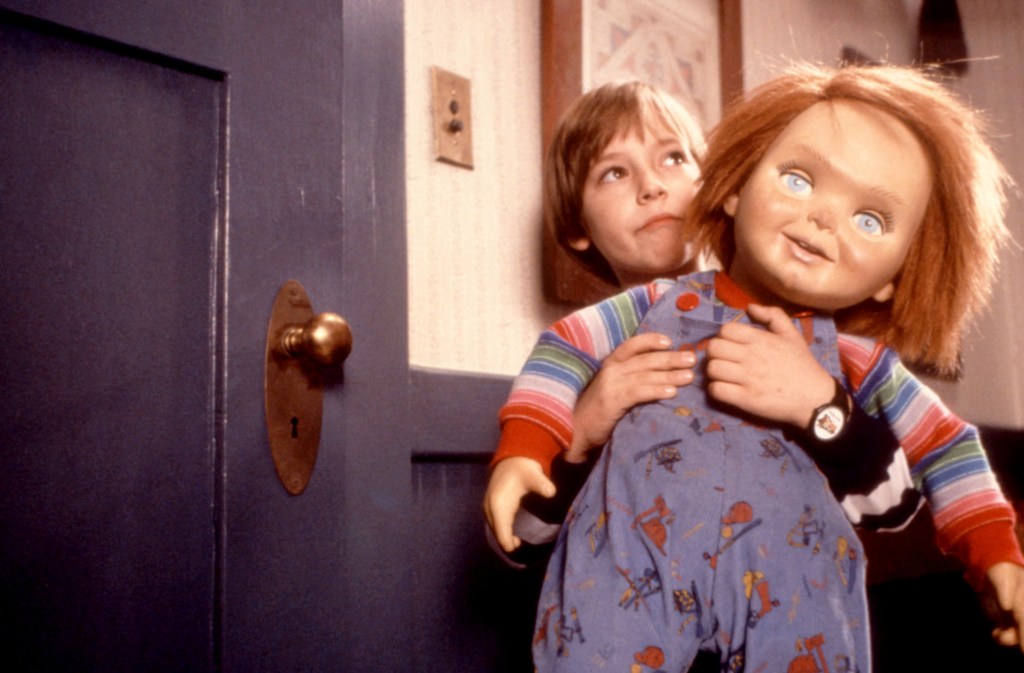 Alex Vincent holding Chucky the doll in Child's Play 2.