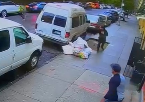 The gunman in a high-vis vest runs across the street as Bautista holds his chest where he was struck by the bullet.