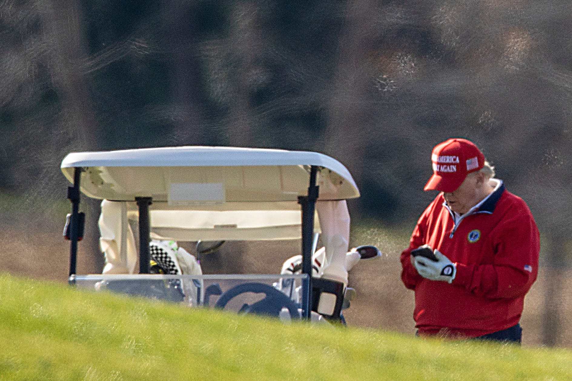 Trump makes a call while golfing at his Virginia club in 2020