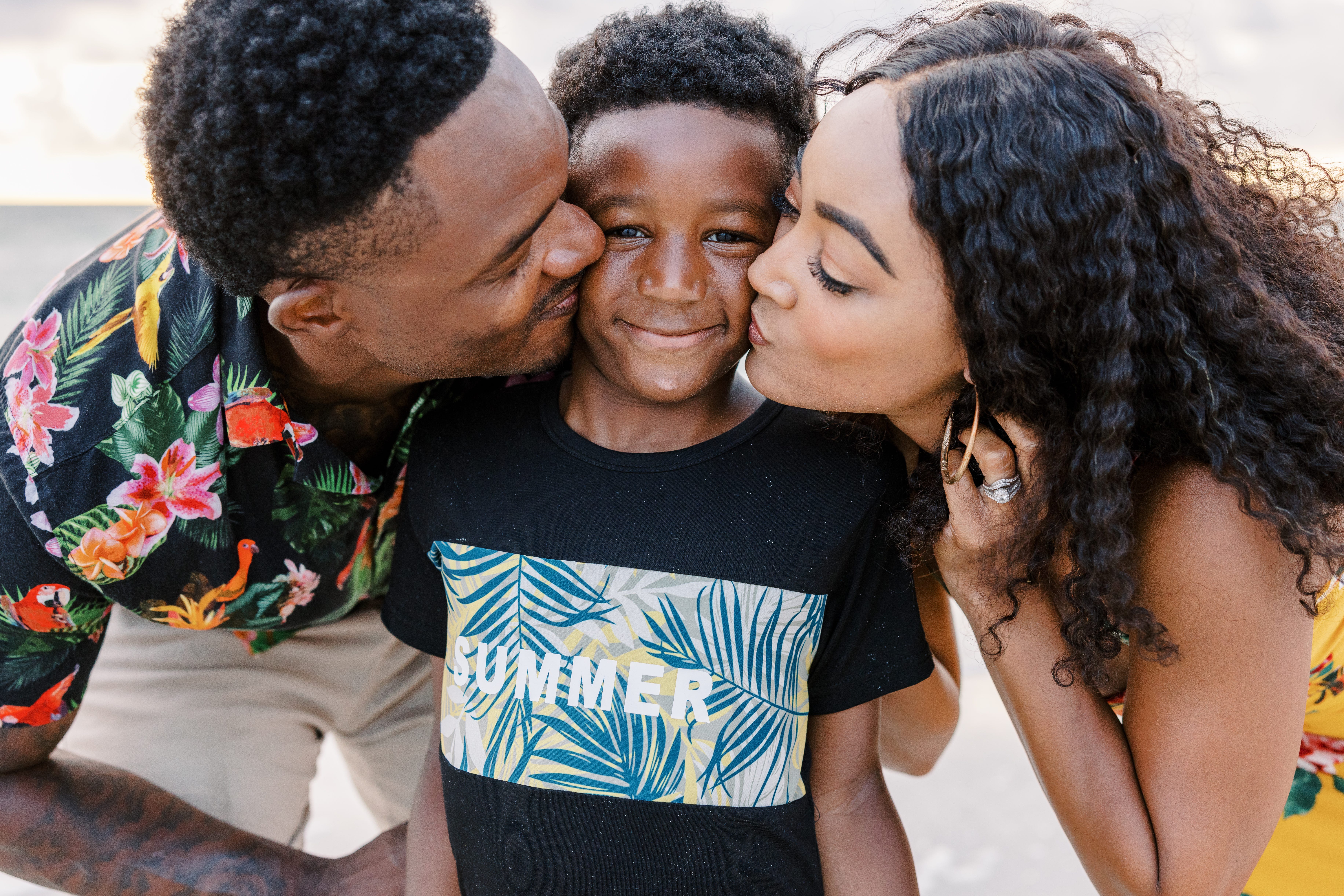 Jenna Scott and her husband kissing their son.