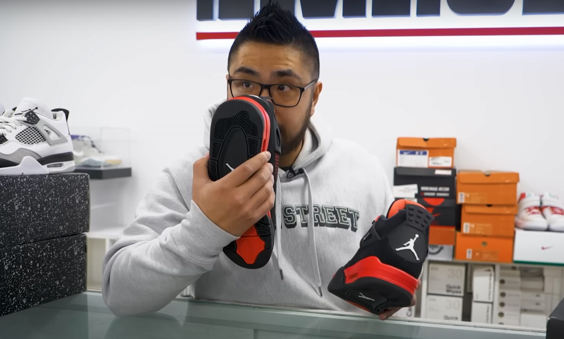 Shu Cheng sniffing a pair of sneaker to authenticate them