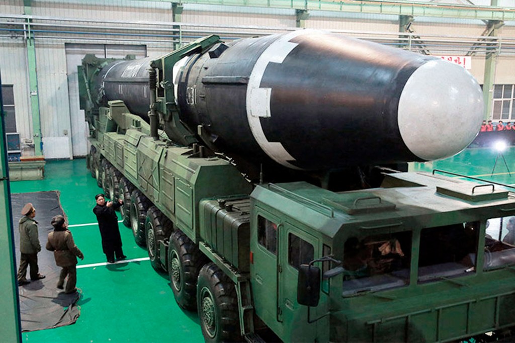 North Korean government shows North Korean leader Kim Jong Un, third from left, and what the North Korean government calls the Hwasong-15 intercontinental ballistic missile, in North Korea. Public sentiment in Japan toward North Korea is generally negative.
