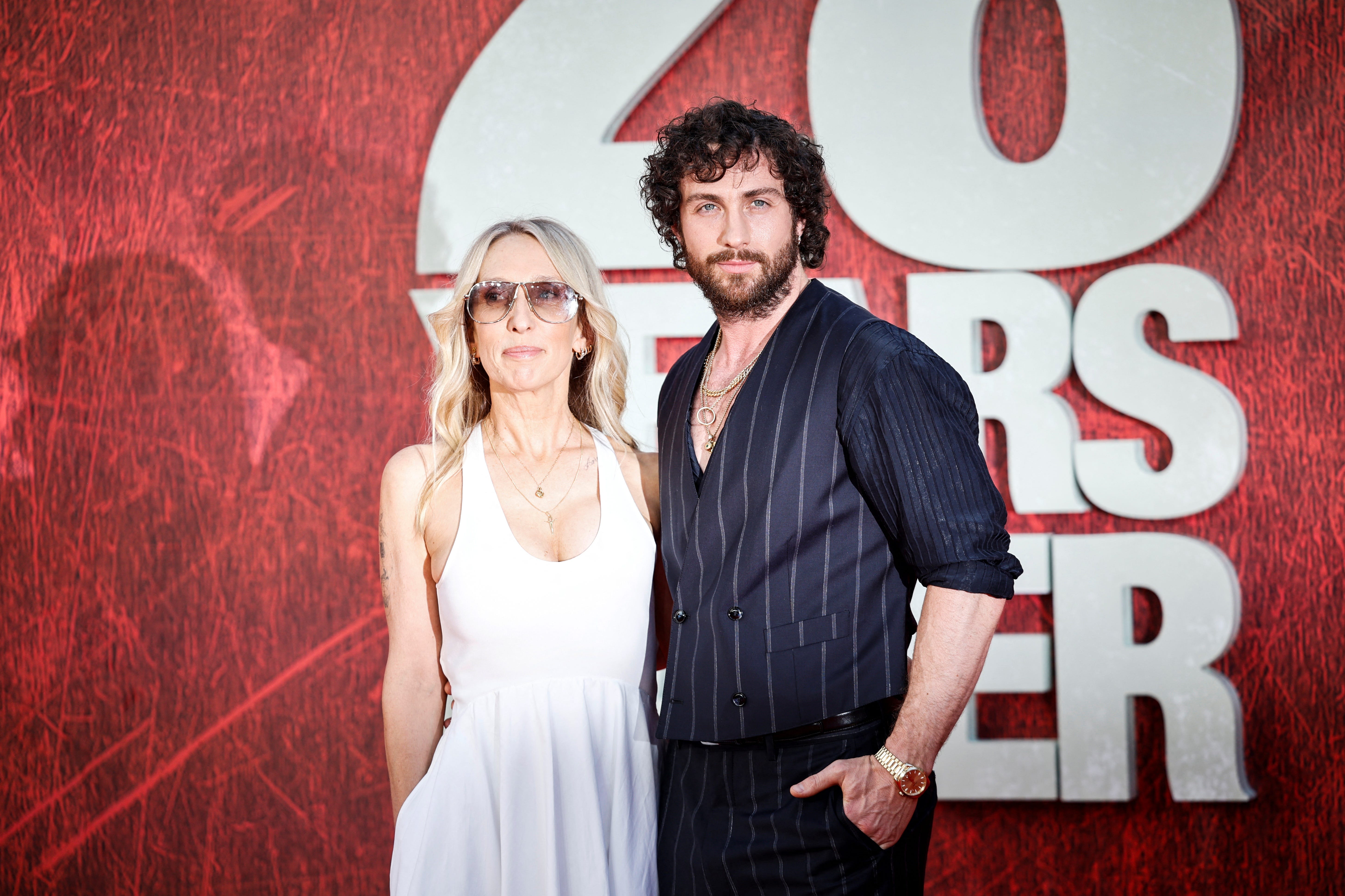 Sam Taylor-Johnson in a white dress, Aaron Taylor-Johnson in a jacket