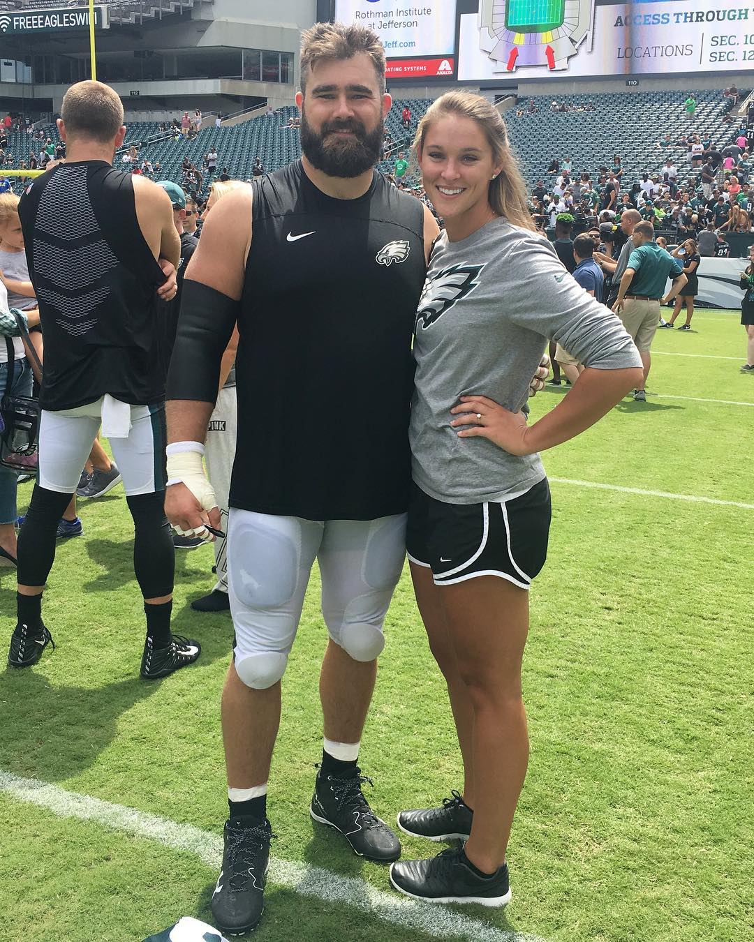 Jason and Kylie Kelce on a football field