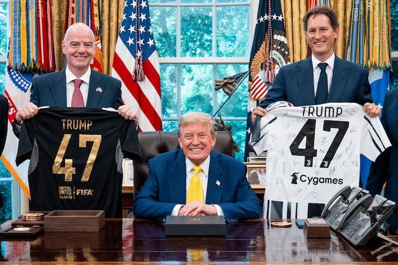FIFA President Gianni Infantino and Exor chief John Elkann present Donald Trump with soccer jerseys in the Oval Office.