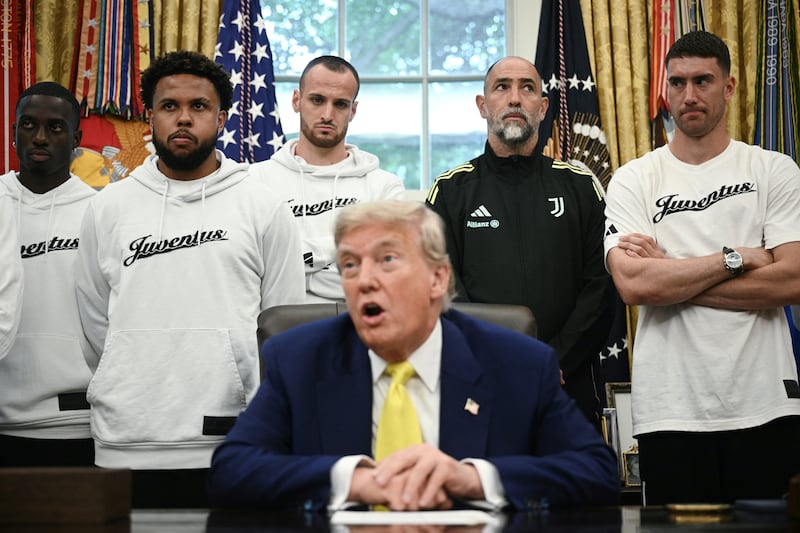 The soccer players awkwardly looked on as Trump fielded political questions in the Oval Office.