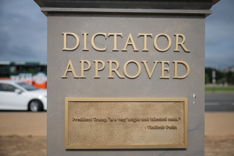 A plaque on the "Dictator Approved" statue shows a quote from Vladimir Putin: "President Trump is a very bright and talented man."