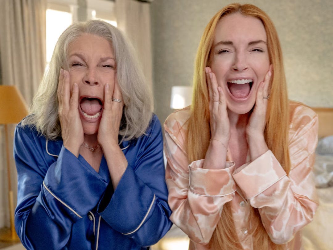 Jamie Lee Curtis and Linday Lohan screaming with their hands to their cheeks