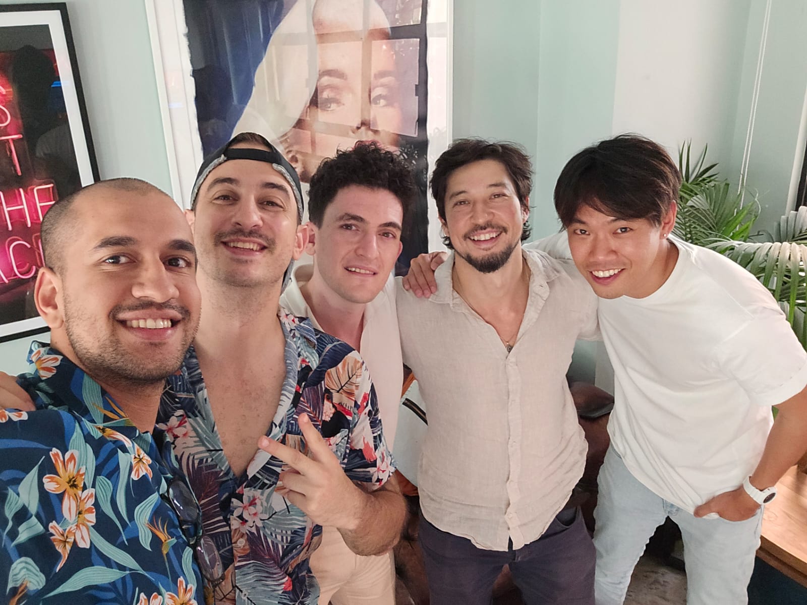 Five young men smiling.