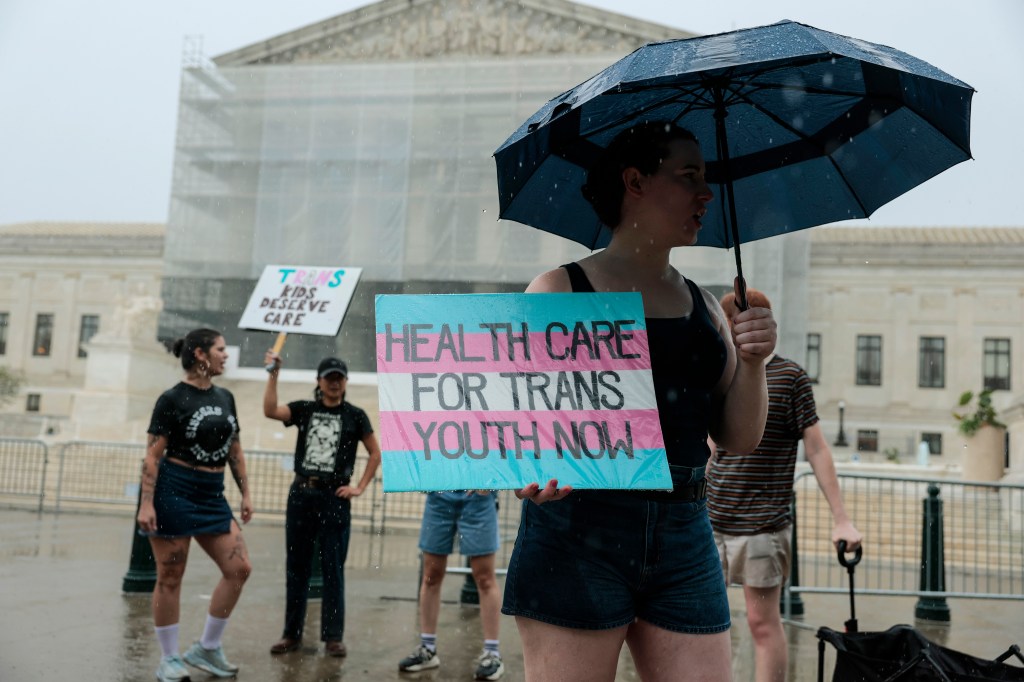 Protestors rally against the Supreme Court's ban on gender-affirming care for transgender youth.