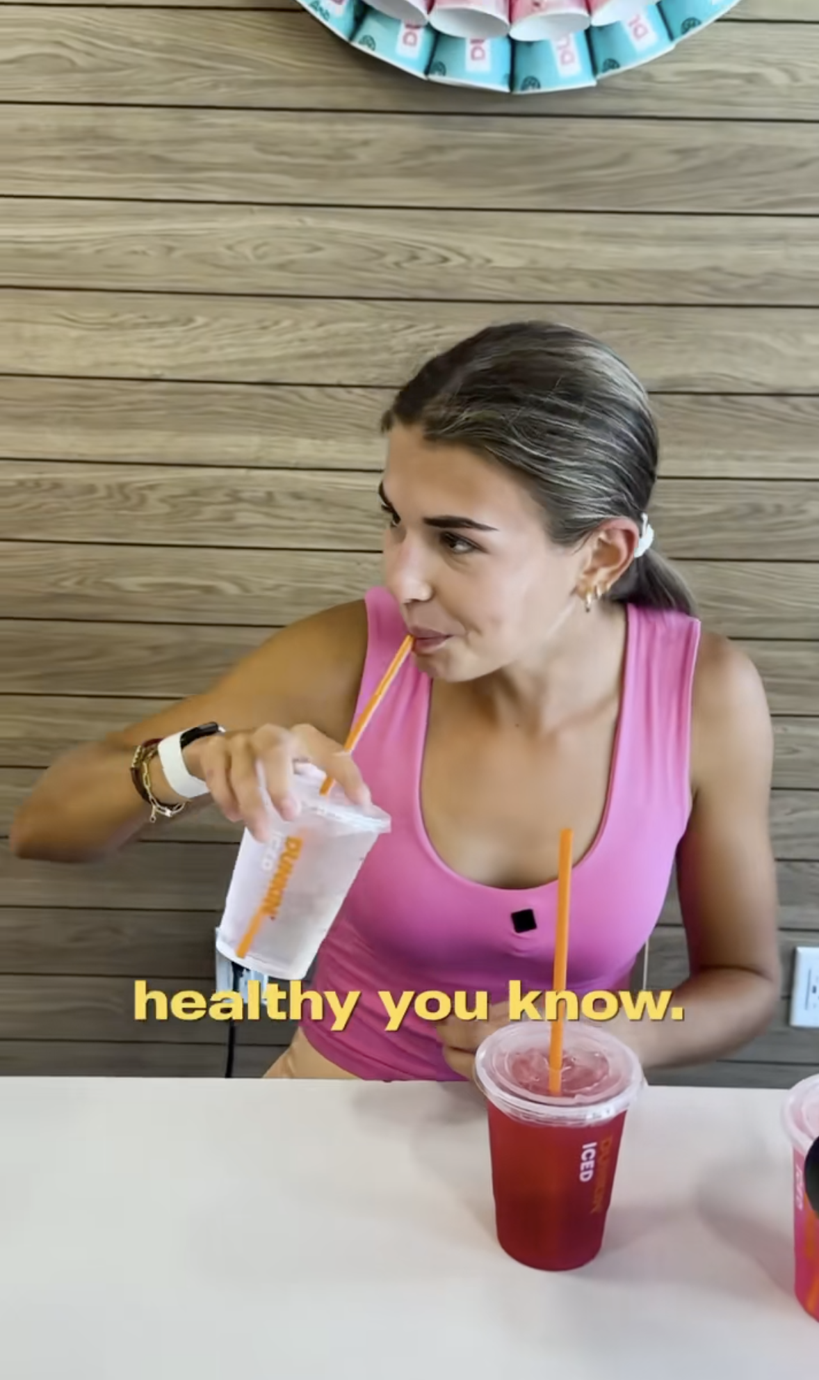 Kai Trump drinks a water at Dunkin' Donuts. 