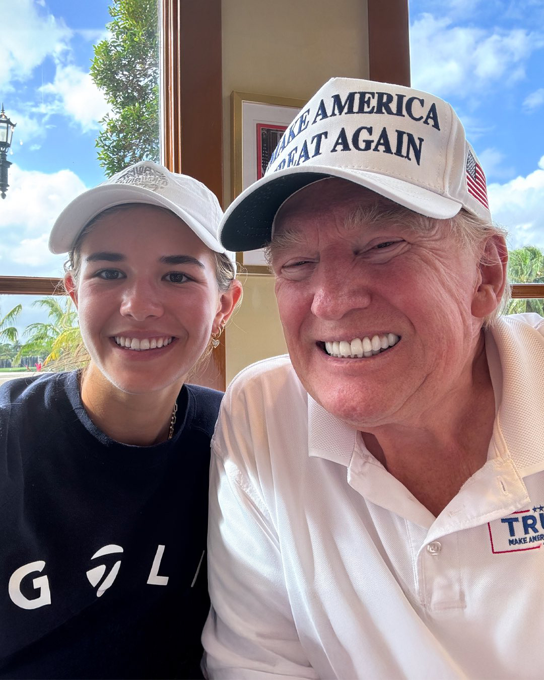 Kai Trump poses for a photo with Donald Trump. 