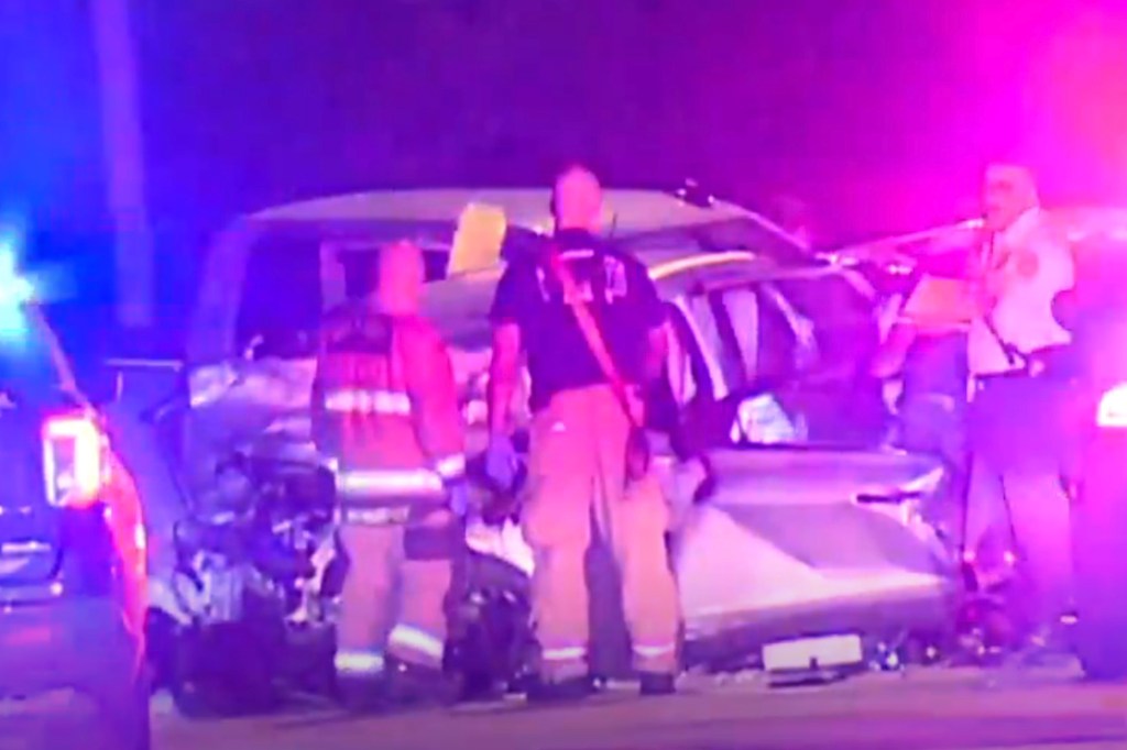 Emergency responders at a car crash scene.